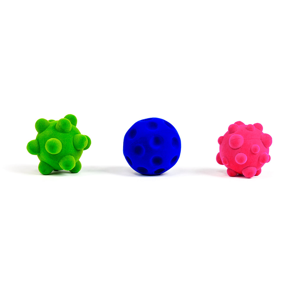 Rubbabu® Stress Balls 2.5" Balls. PInk bumpy ball, green bumpy ball, and blue crater ball.