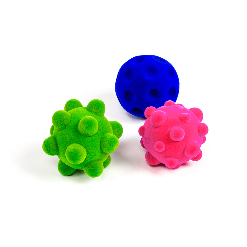 Rubbabu® Stress Balls 2.5" Balls. PInk bumpy ball, green bumpy ball, and blue crater ball.