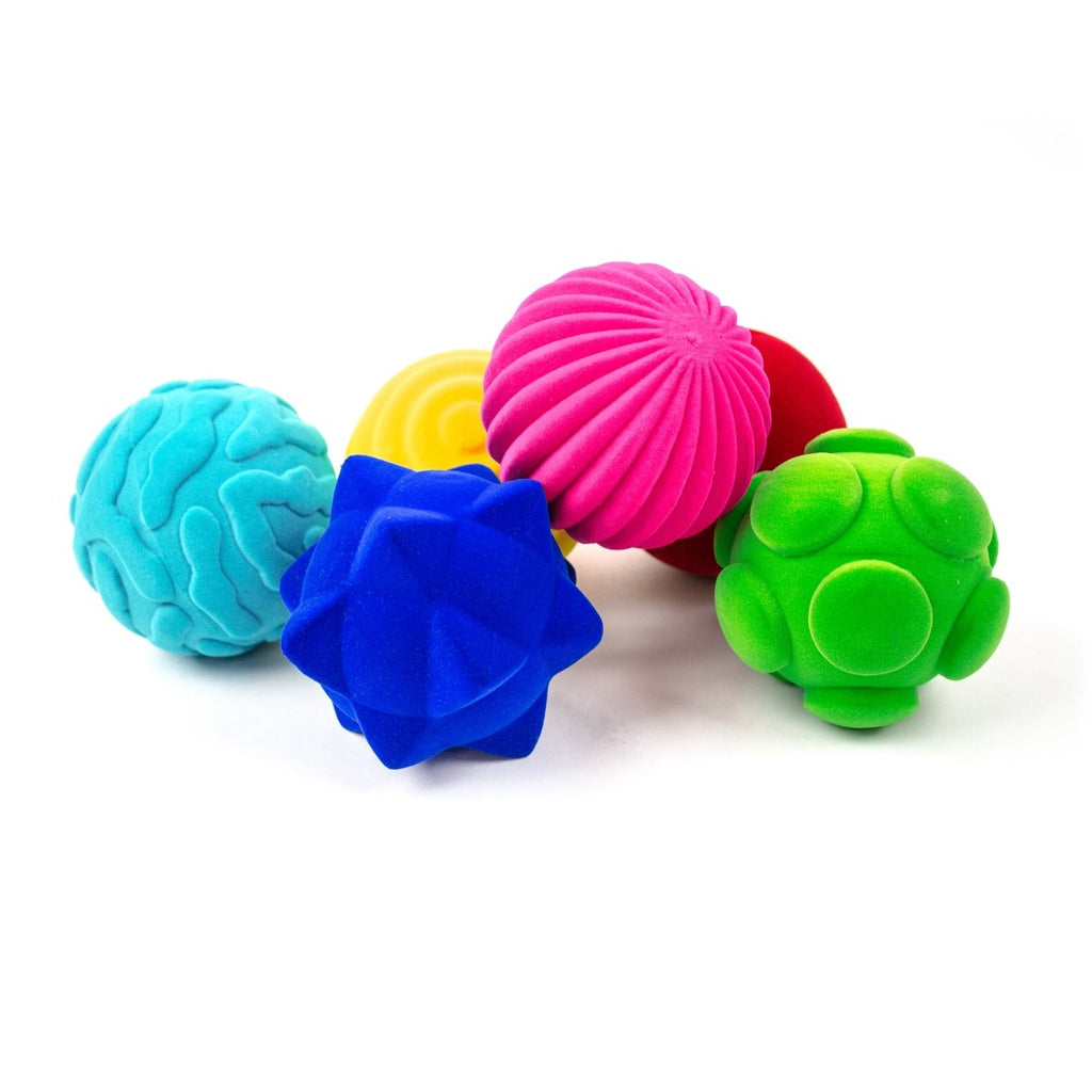 Rubbabu® Whacky Ball Assortment with a pink ball, green ball, red ball, blue ball, turquoise ball, and yellow ball that each have a different texture.